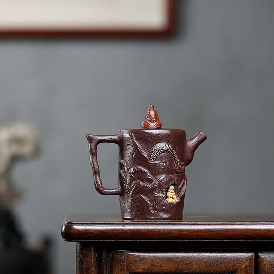 Handmade Yixing purple sand teapot featuring intricate designs, perfect for home Kung Fu tea sets.