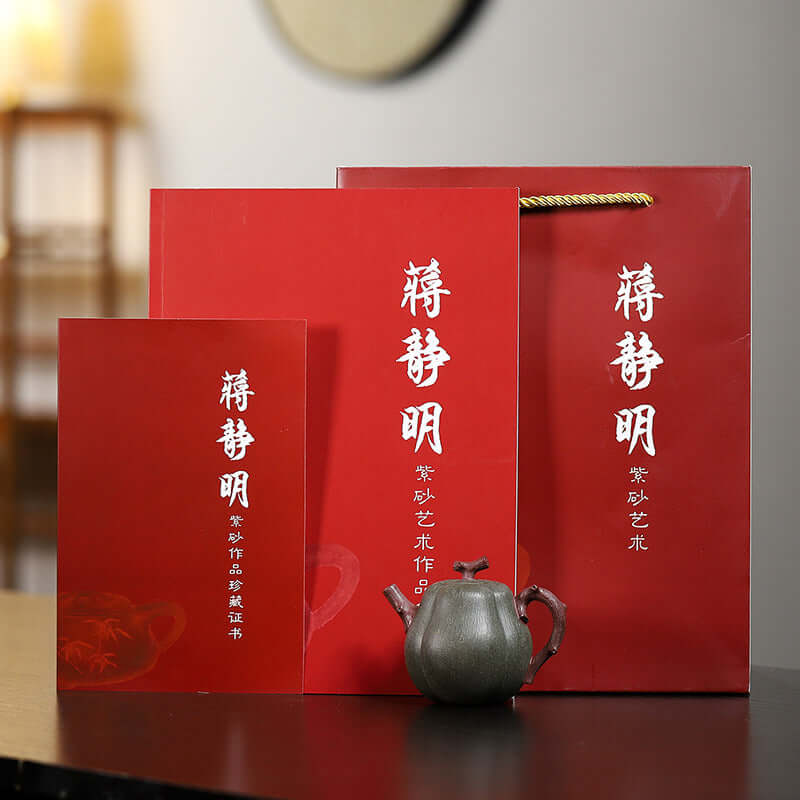 Red packaging and certificate for handmade Yixing purple sand teapot by craftsman Jiang Jingming.