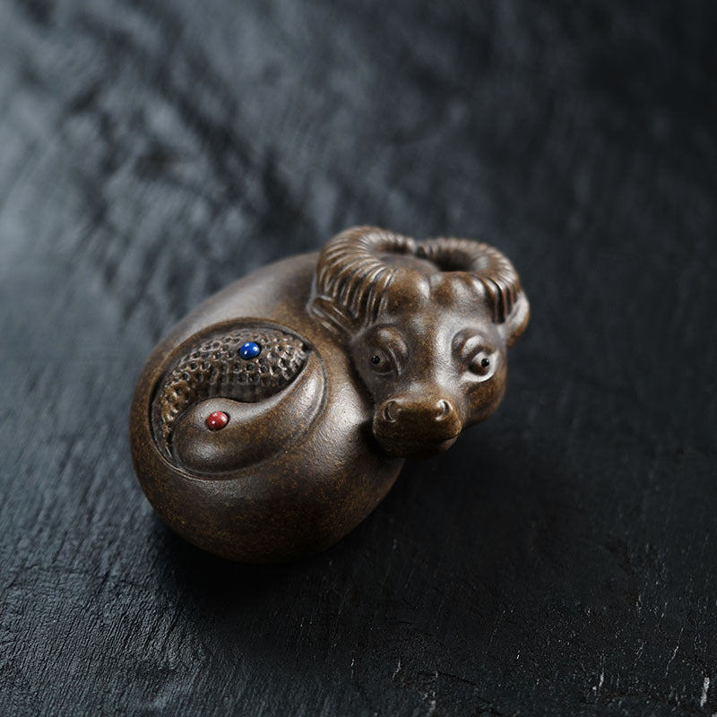 Handmade Yixing purple sand ox ornament with Tai Chi design, perfect for tea play and as a decorative tea table accent.