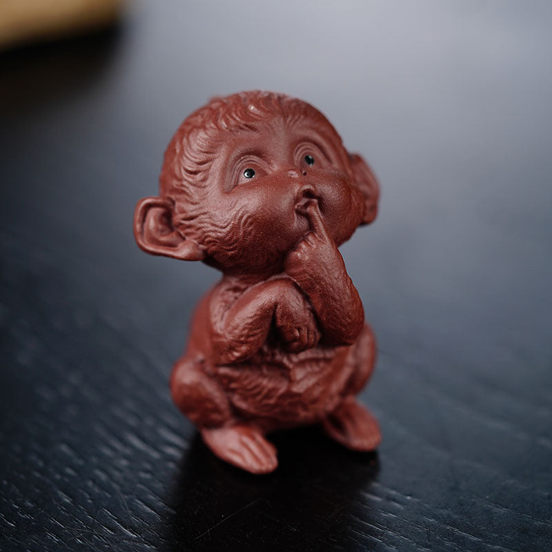 Handmade Yixing purple sand tea pet sculpture of a monkey, perfect for tea table decor and artistic ornamentation.