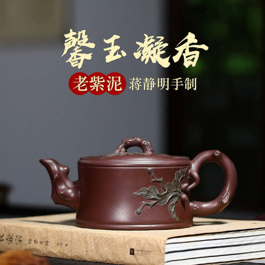 Handmade Yixing purple sand teapot by craftsman Jiang Jingming, featuring intricate leaf design and elegant finish.