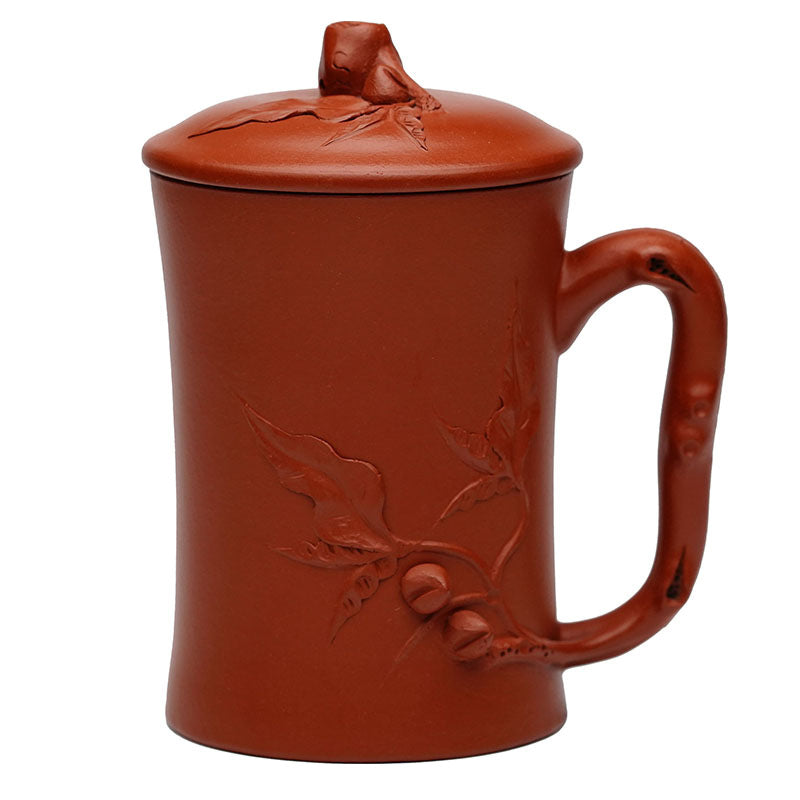 Handmade Yixing purple sand tea cup with a decorative lid, featuring intricate leaf design, perfect for tea lovers.