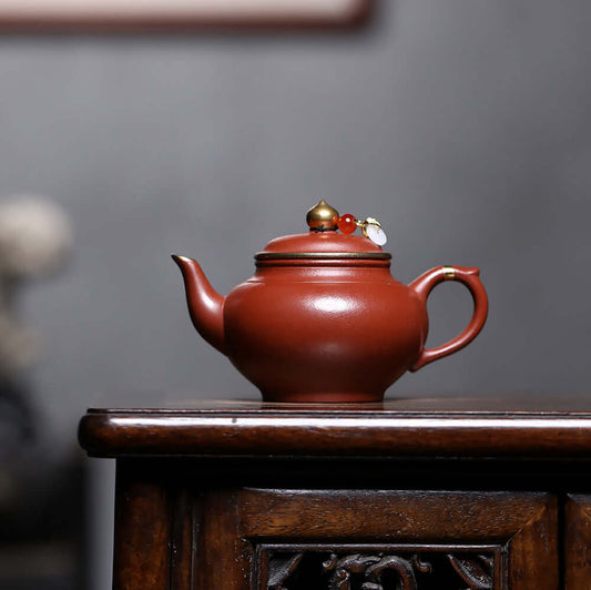 Handmade Yixing purple sand teapot with gold inlaid, showcasing a unique wrinkled surface, perfect for Kung Fu tea.