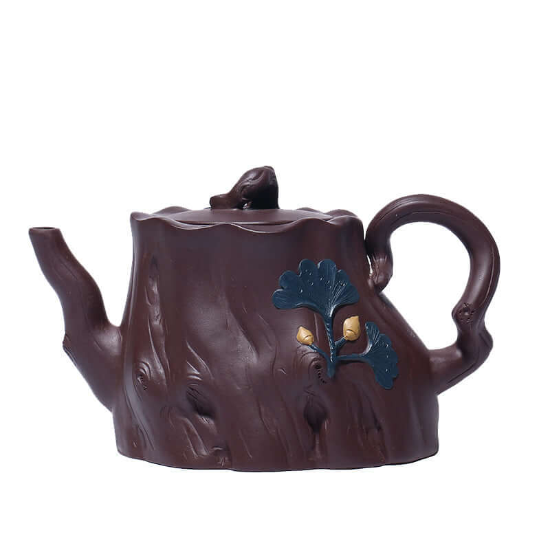 Handmade Yixing purple sand teapot in tree stump design with ginkgo leaves, features rich texture and details.
