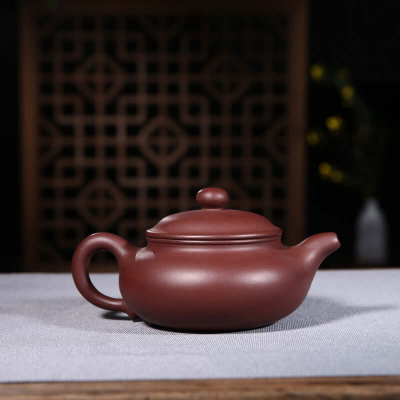 Handmade Yixing purple sand teapot showcasing elegant design and craftsmanship, perfect for tea enthusiasts.