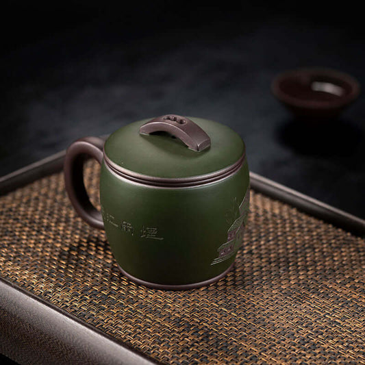 Handmade Yixing purple sand cup with green mud finish, ideal for tea enthusiasts and collectors.