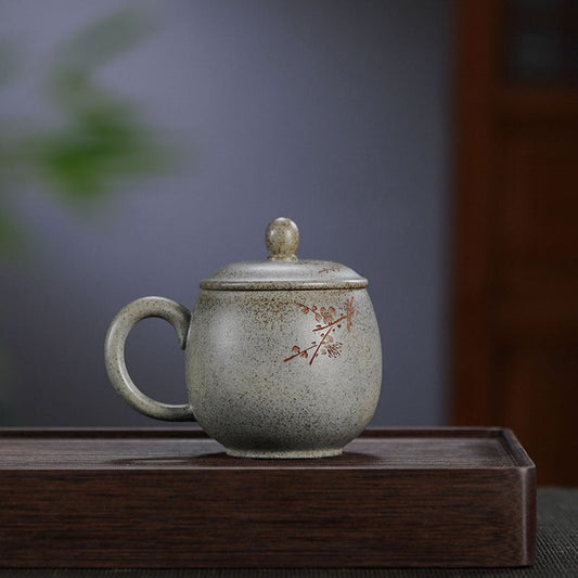 Handmade Yixing purple sand cup with lid, featuring plum blossom design, perfect for tea lovers.