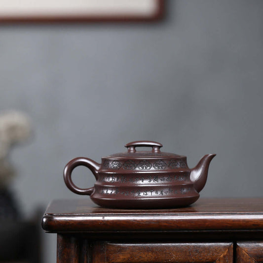 Handmade Yixing purple sand teapot with intricate design, perfect for kung fu tea sets, showcasing traditional craftsmanship.
