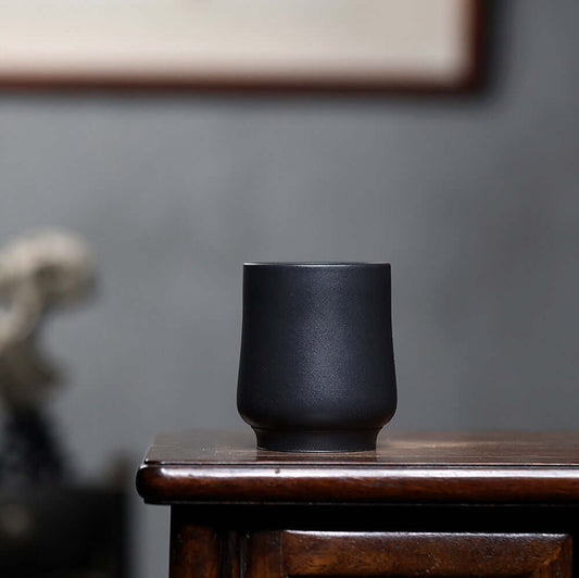 Handmade Yixing purple sand tea cup showcasing raw ore design, perfect for home kung fu tea set.