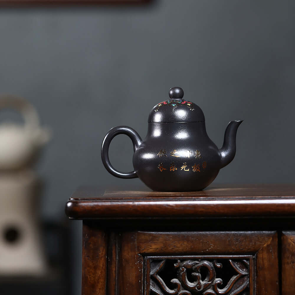 Handmade Yixing purple sand teapot in black iron stone with yellow enamel, perfect for kung fu tea sets.