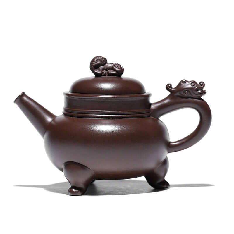 Handmade Yixing purple sand teapot in a traditional design, featuring a dragon-shaped handle and lion knob.