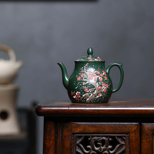 Handmade Yixing purple sand teapot in ink green mud with floral design, perfect for home kung fu tea sets.