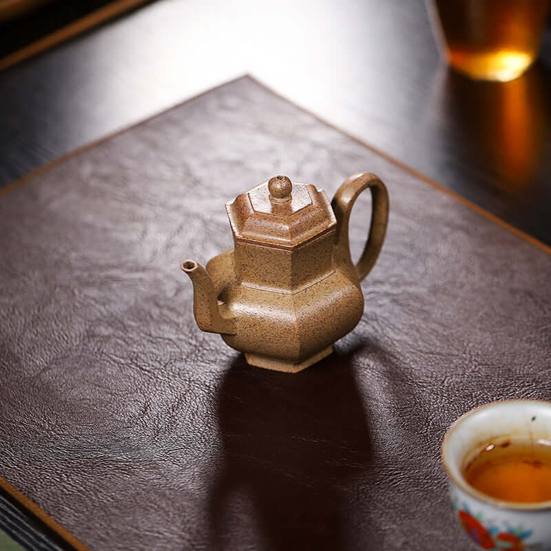 Handmade Yixing purple sand teapot in a hexagonal shape, crafted from original purple sand for tea enthusiasts.
