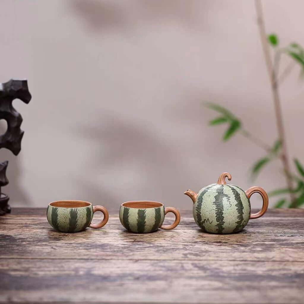 Handmade Yixing purple sand teapot and cups in watermelon design, showcasing original craftsmanship and unique style.
