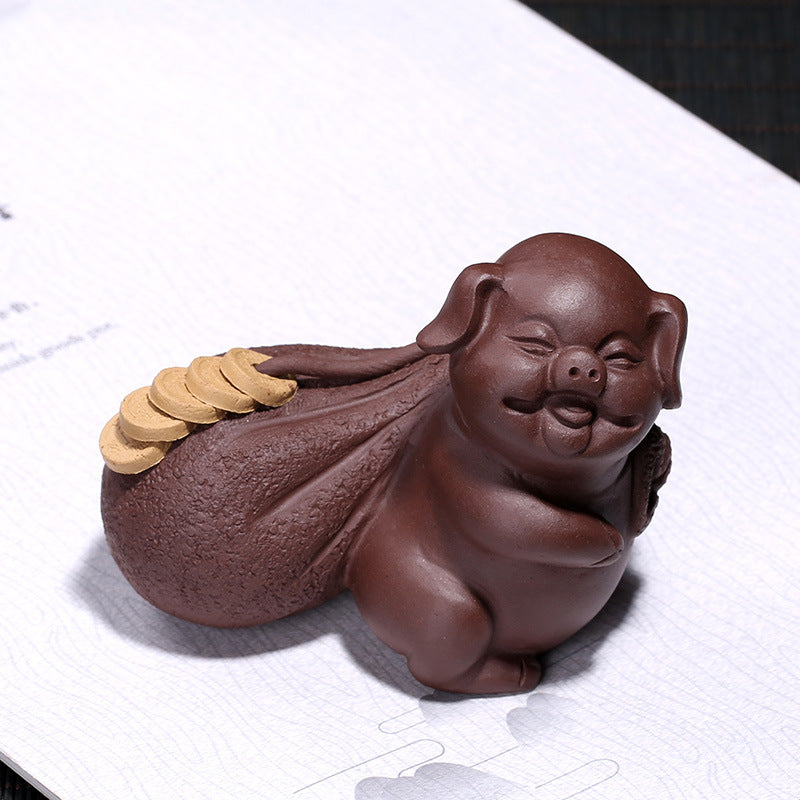 Handmade Yixing purple sand fortune pig tea pet decoration, symbolizing blessing and prosperity for tea lovers.
