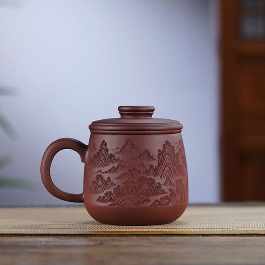 Handmade Yixing purple sand cup with intricate mountain design, featuring a leakage-proof lid, ideal for tea lovers.