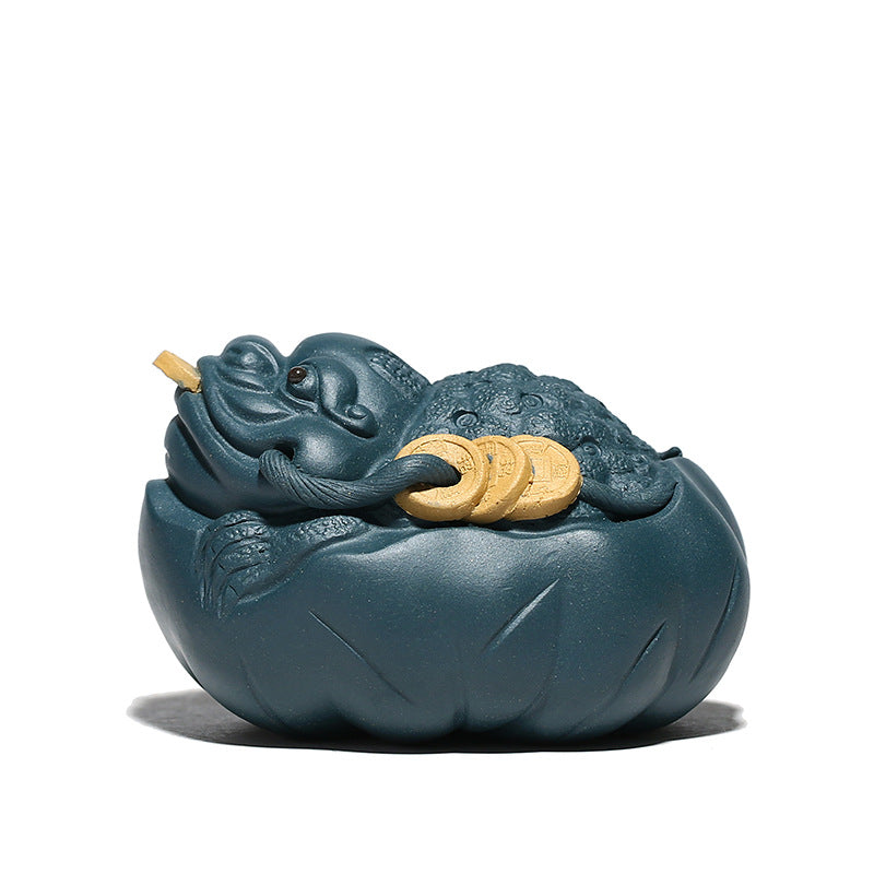 Handmade Yixing purple sand sculpture of a Golden Toad resting on a lotus leaf, perfect for tea ceremony decoration.