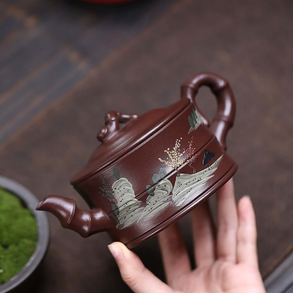 Handmade Yixing purple sand teapot featuring painted landscape and bamboo design, perfect for kung fu tea sets.