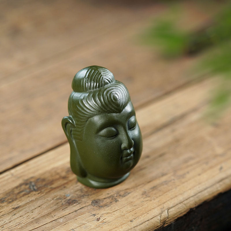 Handmade green Buddha head ornament, crafted from Yixing purple sand, perfect for home decor and tea ceremonies.