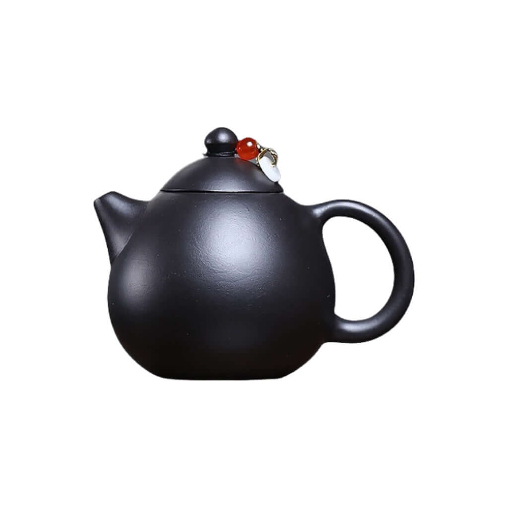 Handmade Yixing purple sand teapot with a sleek black finish, ideal for home Kung Fu tea sets, crafted by Yixing artisans.