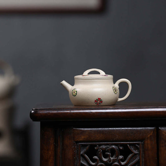 Handmade Yixing purple sand teapot with floral design, perfect for Kung Fu tea ceremonies and traditional home decor.