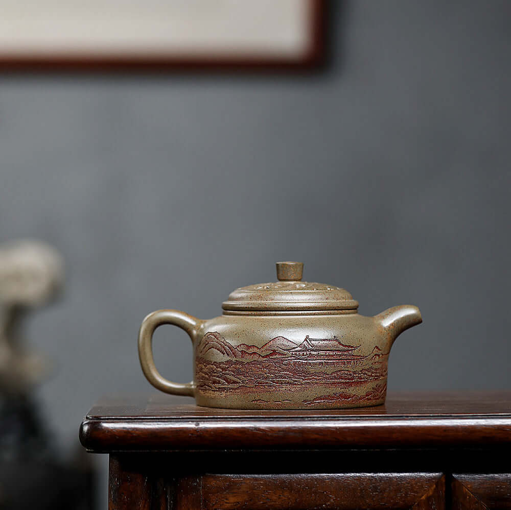 Handmade Yixing purple sand teapot with intricate mountain design, perfect for home tea sets.