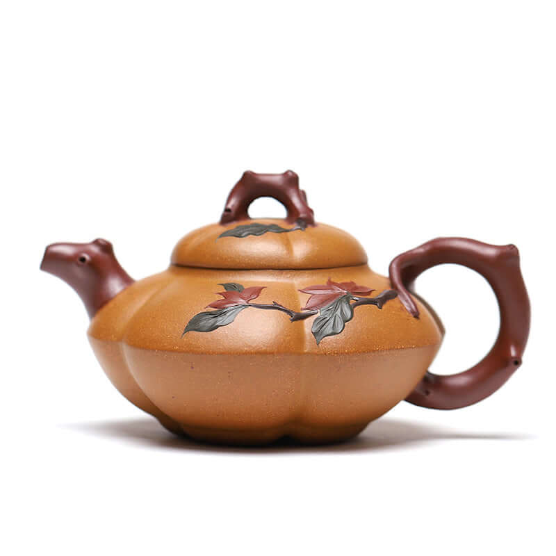 Handmade Yixing purple sand teapot with floral design and pumpkin shape, showcasing craftsmanship in ceramic art.