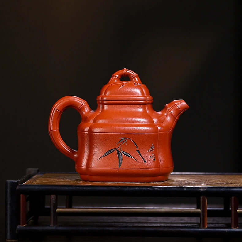 Handmade Yixing purple sand teapot with bamboo design, artisan crafted original clay for home use.