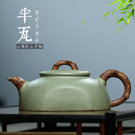 Handmade Yixing purple sand teapot in bean green clay with intricate twisted handle detail.