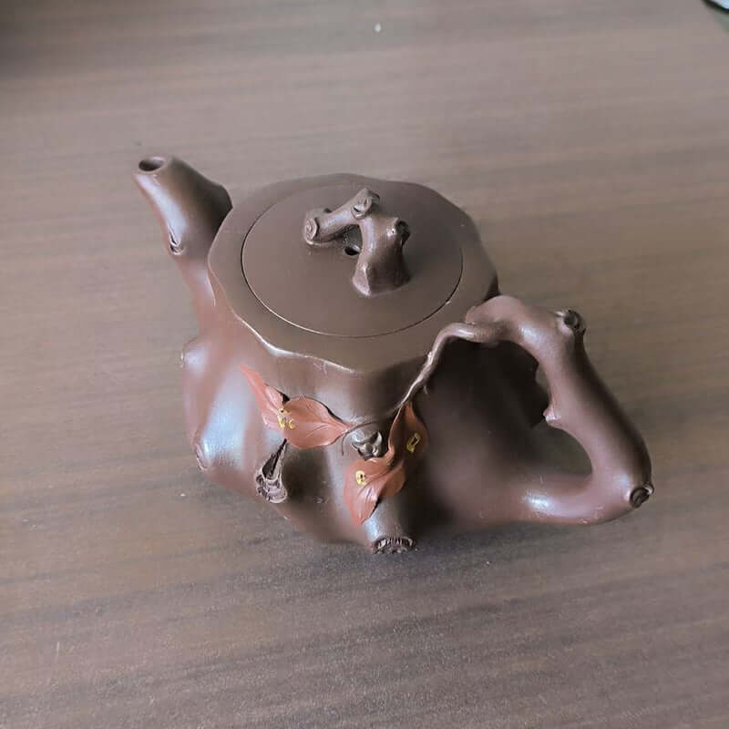 Handmade Yixing purple sand teapot designed as a tree stump, crafted using original purple sand by skilled artisans.