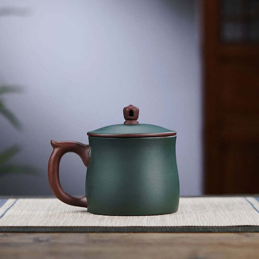 Handmade Yixing purple sand cup with a green finish, designed for tea lovers, showcasing high-end craftsmanship.