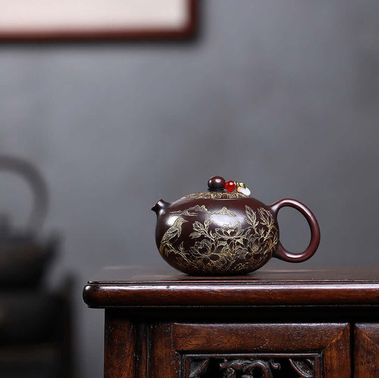 Handmade Yixing purple sand teapot, crafted with floral engravings, perfect for traditional tea ceremonies.