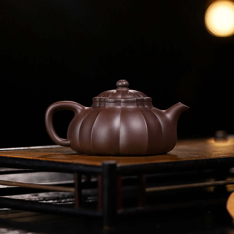 Handmade Yixing purple sand teapot with ribbed design, perfect for home brewing tea. High-quality, original craftsmanship.