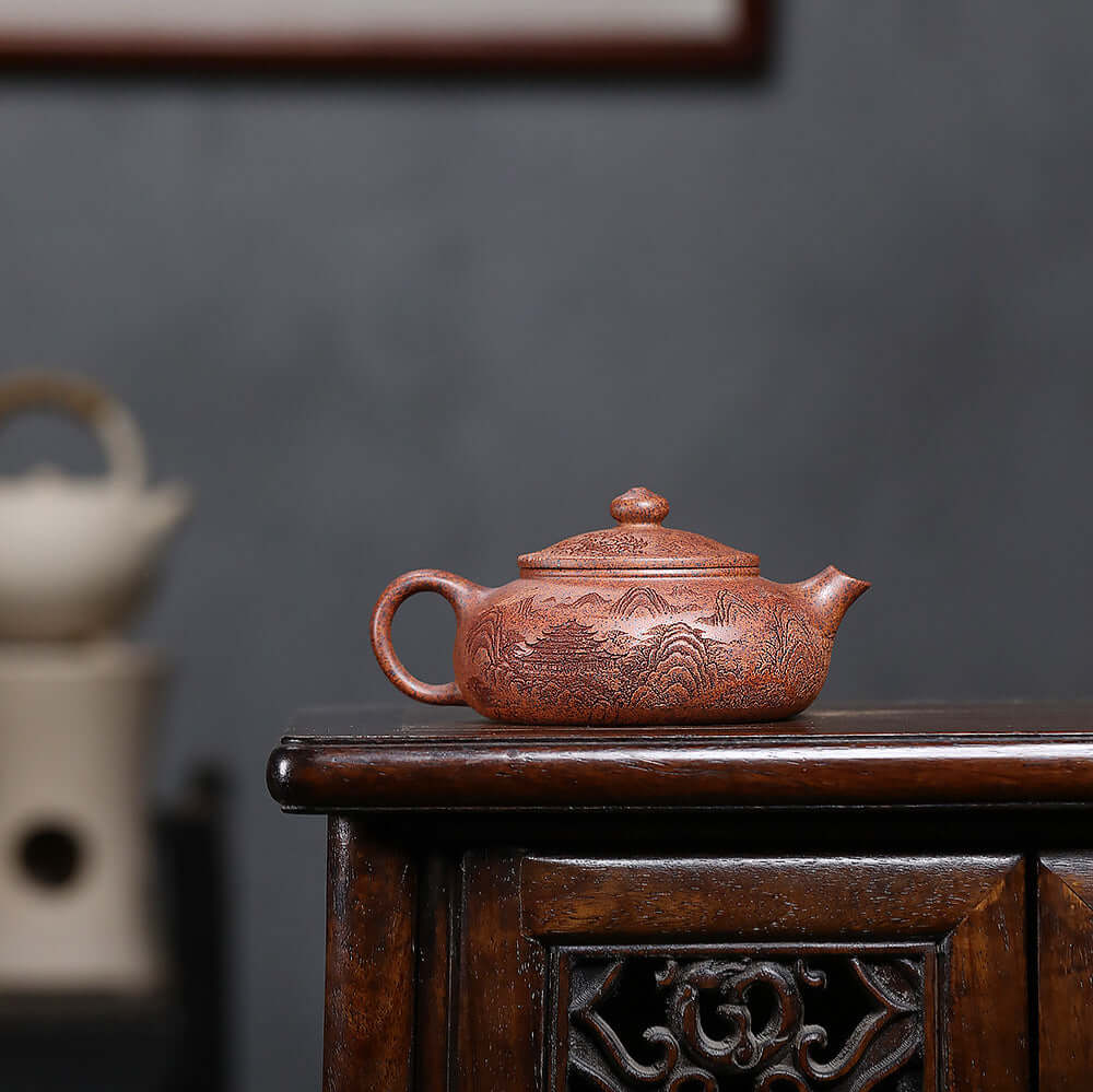 Handmade Yixing purple sand teapot featuring intricate design, perfect for Kung Fu tea sets.