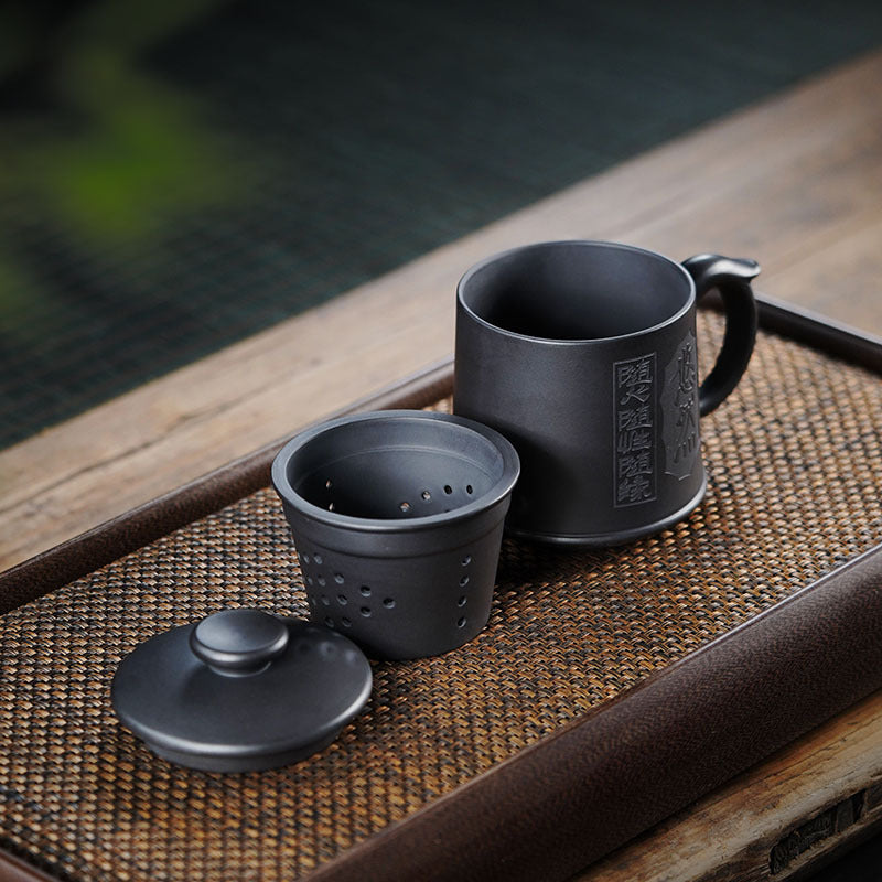Handmade Yixing purple sand tea set featuring a cup and infuser, perfect for gifting relatives and friends.
