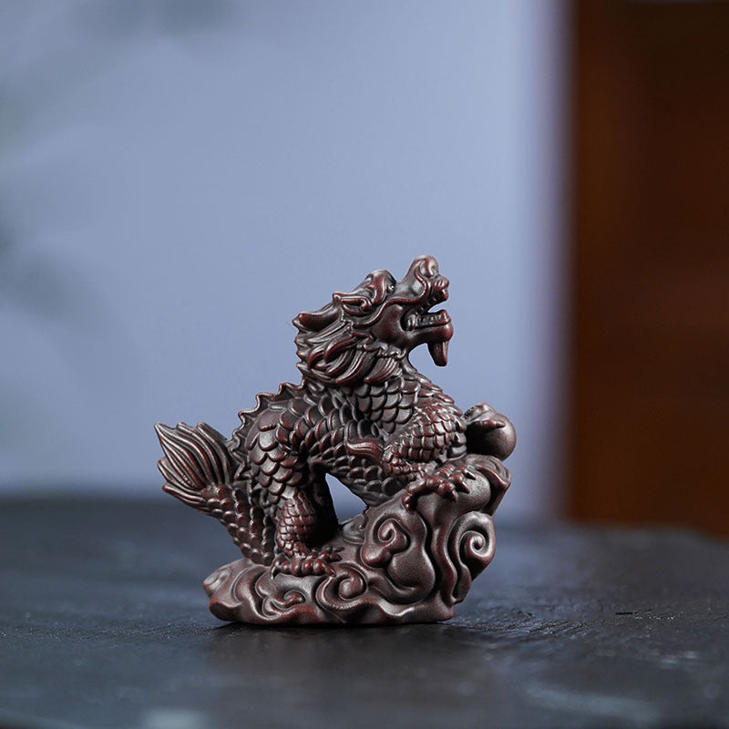 Handmade Yixing purple sand Xiangyun dragon tea pet ornament for tea ceremonies and home decor.