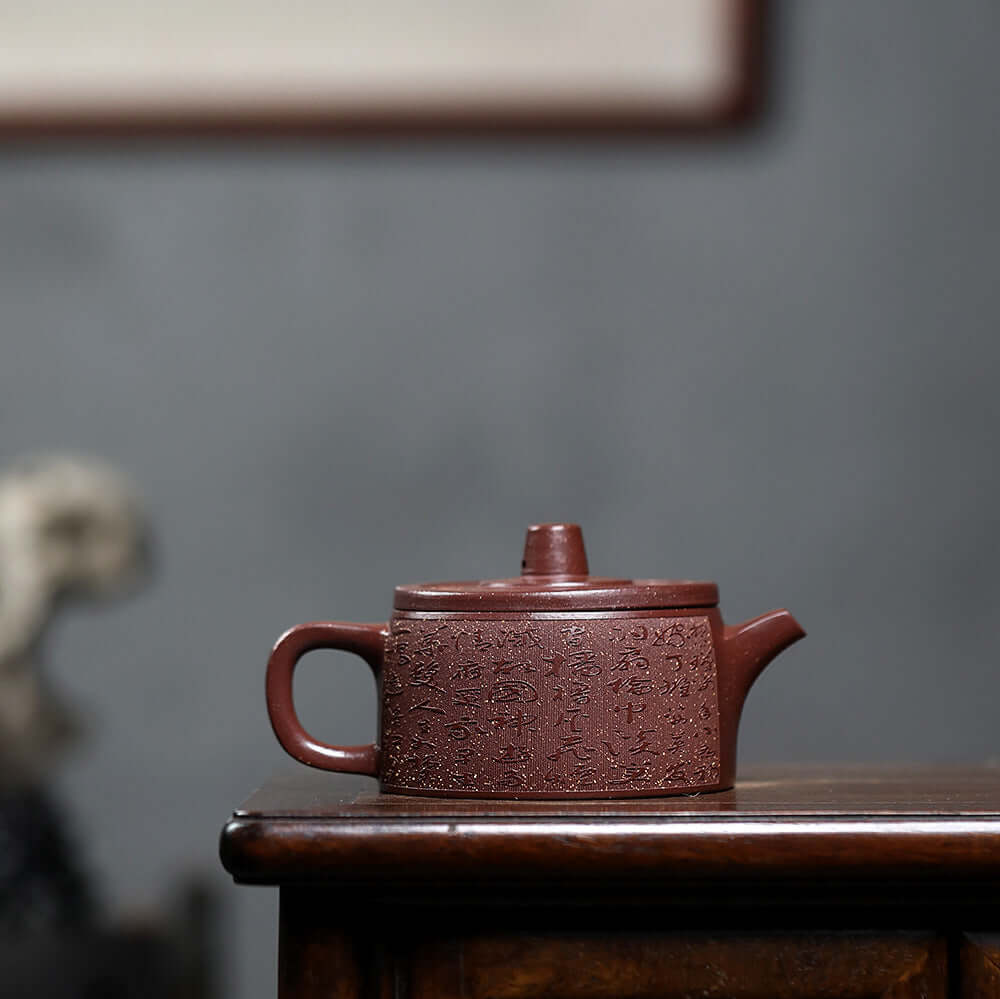 Handmade Yixing purple sand teapot with intricate design, perfect for home kung fu tea set and elegance in tea ceremonies.