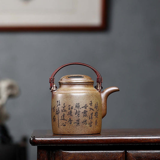 Handmade Yixing purple sand teapot with cow cover, featuring intricate calligraphy, perfect for kung fu tea ceremonies.