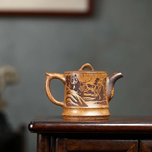 Handmade Yixing purple sand teapot featuring panda design, perfect for tea lovers and collectors.