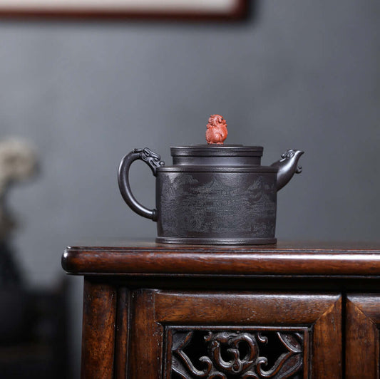 Handmade Yixing purple sand teapot with intricate engravings, featuring a striking lid ornament, perfect for kung fu tea sets.