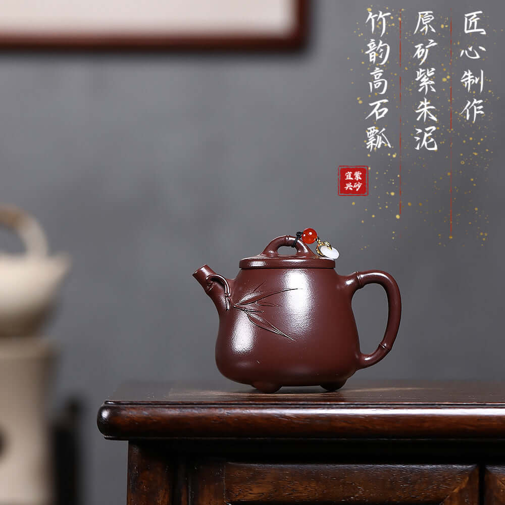 Handmade Yixing purple sand teapot with bamboo design, ideal for Kung Fu tea ceremonies, showcasing high-quality craftsmanship.