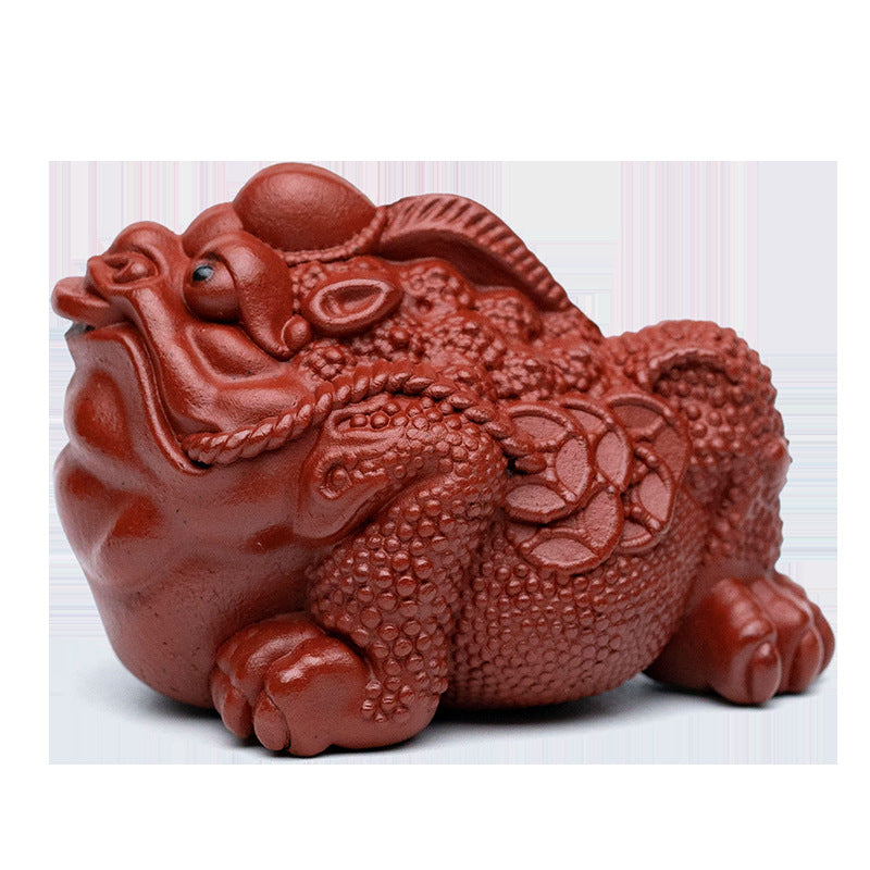 Handmade Yixing purple sand tea pet ornament, depicting a traditional Chinese guardian with intricate details.