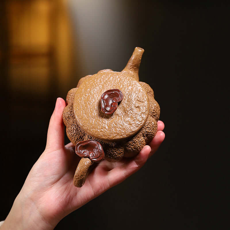 Handmade Yixing purple sand teapot featuring a unique tree stump design with Ganoderma lucidum decorations.