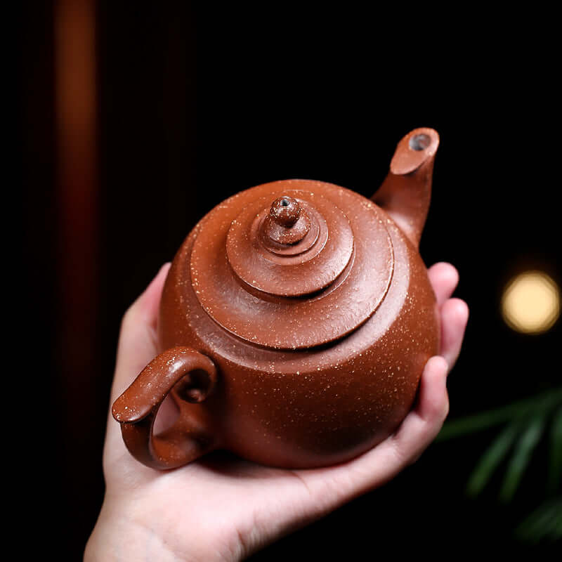 Handmade Yixing purple sand teapot, featuring a unique spiral lid and two handles, perfect for kung fu tea ceremonies.