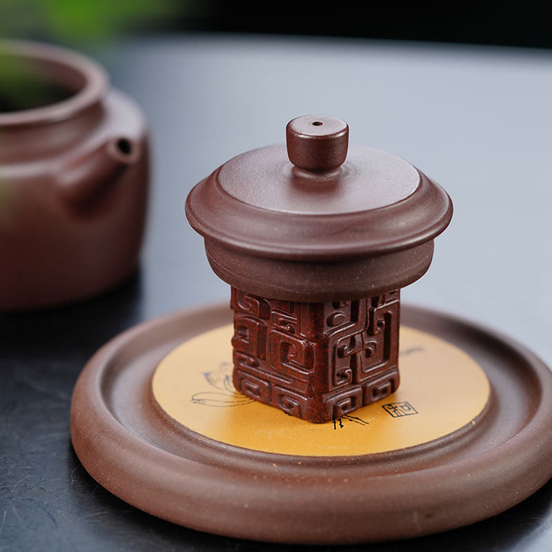 Handmade Yixing purple sand tea pet with embossed totem pattern, traditional Chinese tea set accessory.