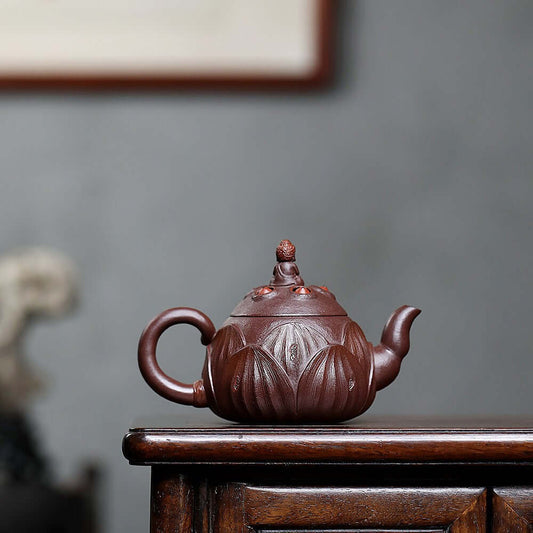 Handmade Yixing purple sand teapot featuring intricate lotus design, perfect for kung fu tea set enthusiasts.