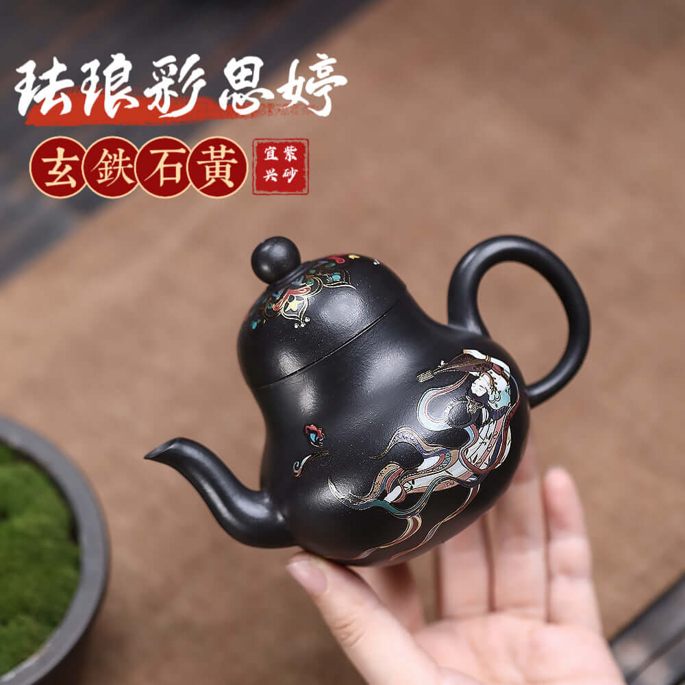 Handmade Yixing purple sand teapot crafted from raw ore black iron stone with intricate enamel designs.