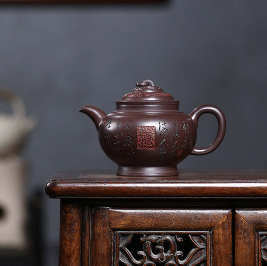 Handmade Yixing purple sand teapot with intricate designs, perfect for kung fu tea sets, showcasing traditional craftsmanship.
