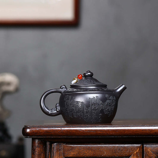 Handmade Yixing purple sand teapot featuring original mineral black iron stone and auspicious prosperity design.