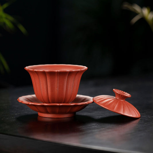 Handmade Yixing purple sand tea cup with chrysanthemum design and slip lid, ideal for tea enthusiasts.